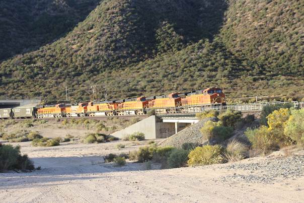 BN-SF 4456, a GE C44-9W; BN-SF 7691, a GE ES44DC; BN-SF 7770, a GE ES44DC; BN-SF 7777, a GE ES44DC; BN-SF 121, a GM GP60M; and BN-SF 8280 a GM SD75MI, lead an empty train of coal cars east.